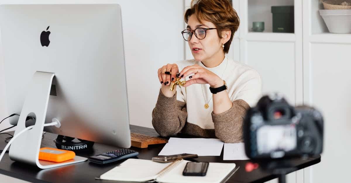 A person sitting at a desk in front of a mirror