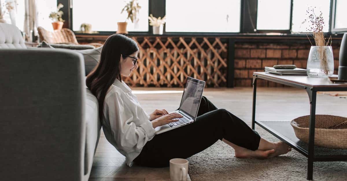 A person sitting at a table using a laptop