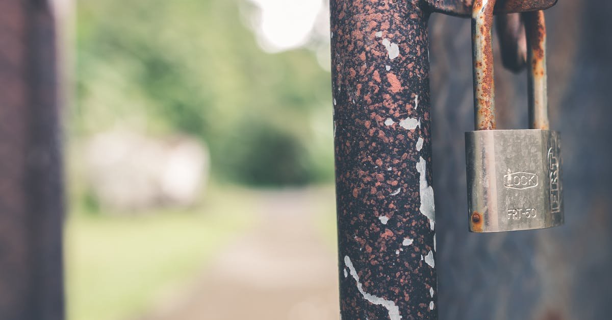 A bird sitting on top of a wooden pole