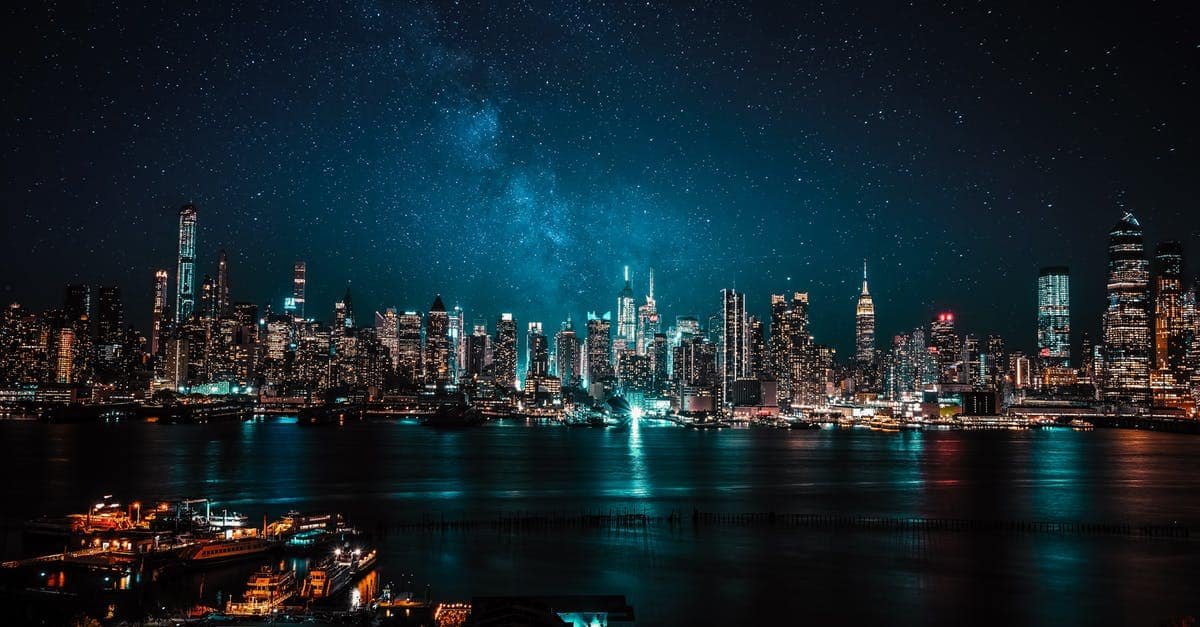 A body of water with a city in the background