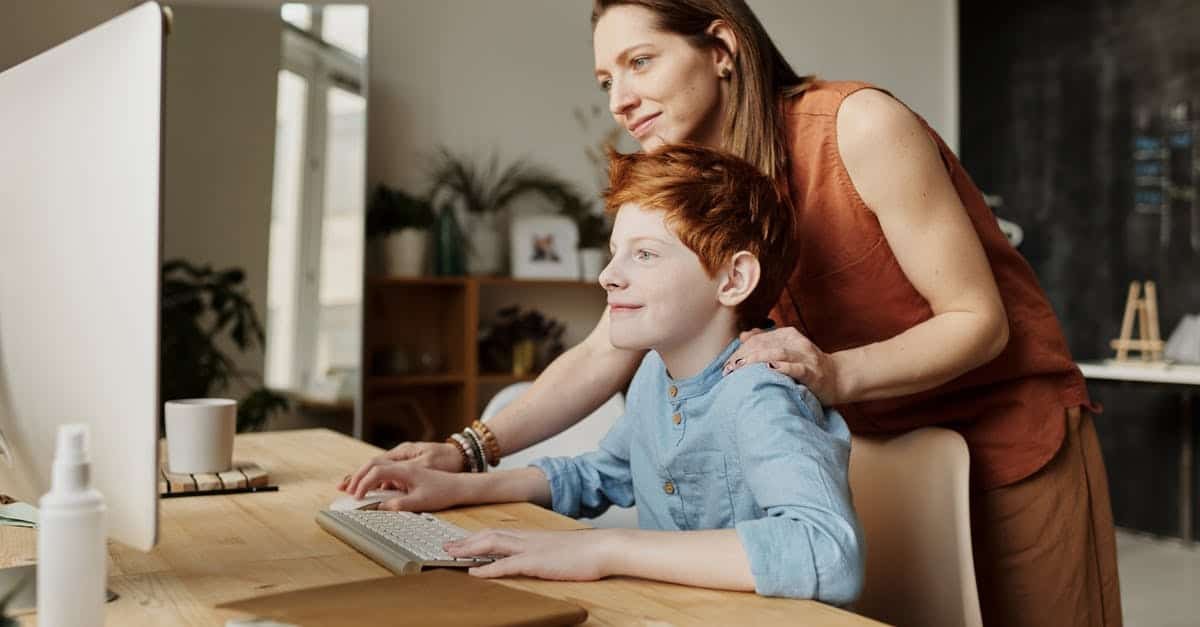A woman sitting at a table using a laptop