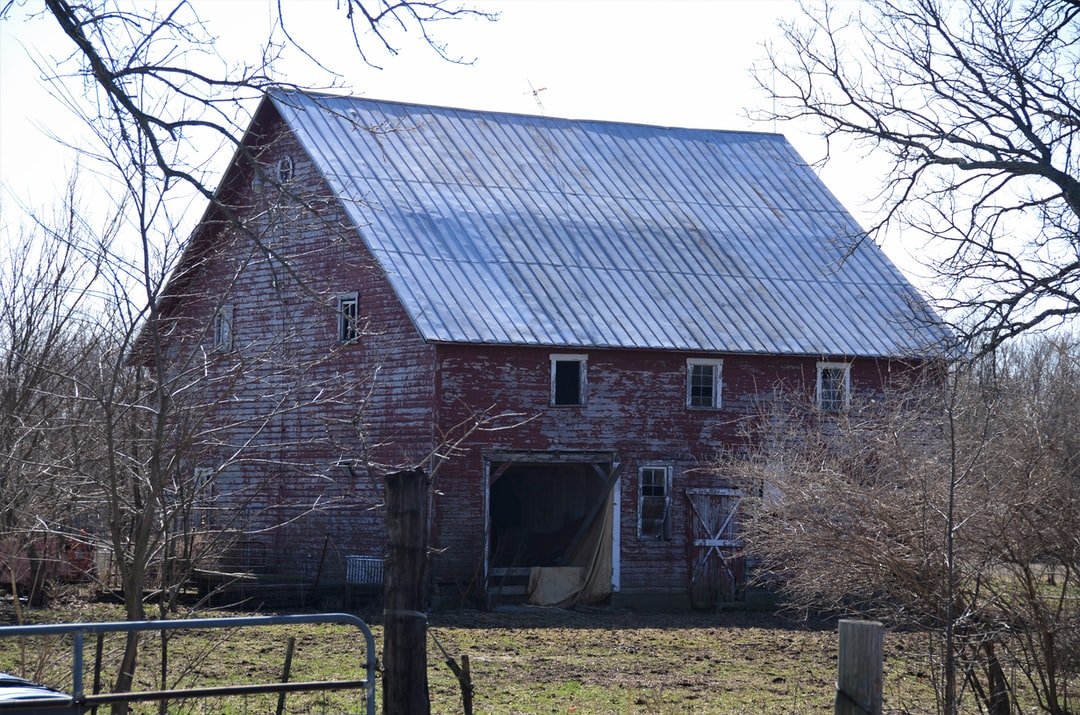 A large brick building with grass in front of a house