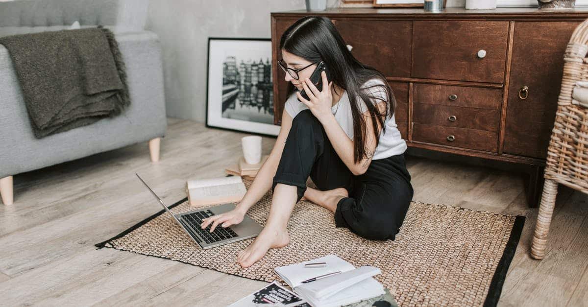 A woman sitting in a chair talking on a cell phone