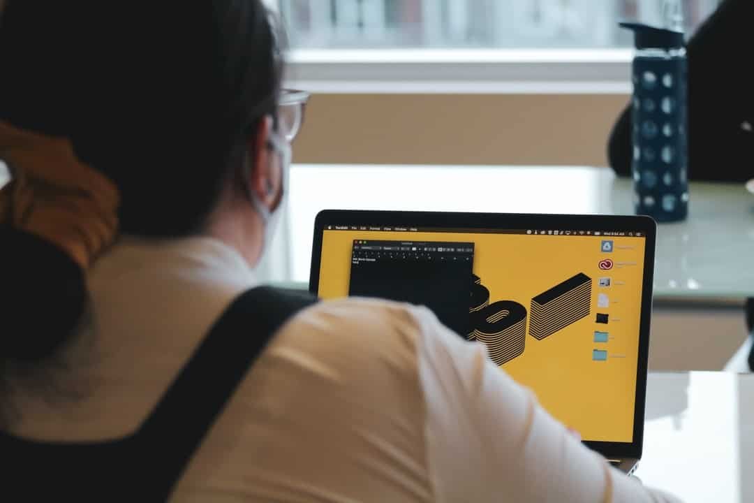 A man sitting in front of a laptop