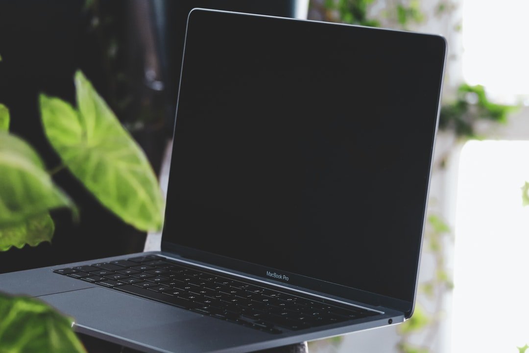 An open laptop computer sitting on top of a table