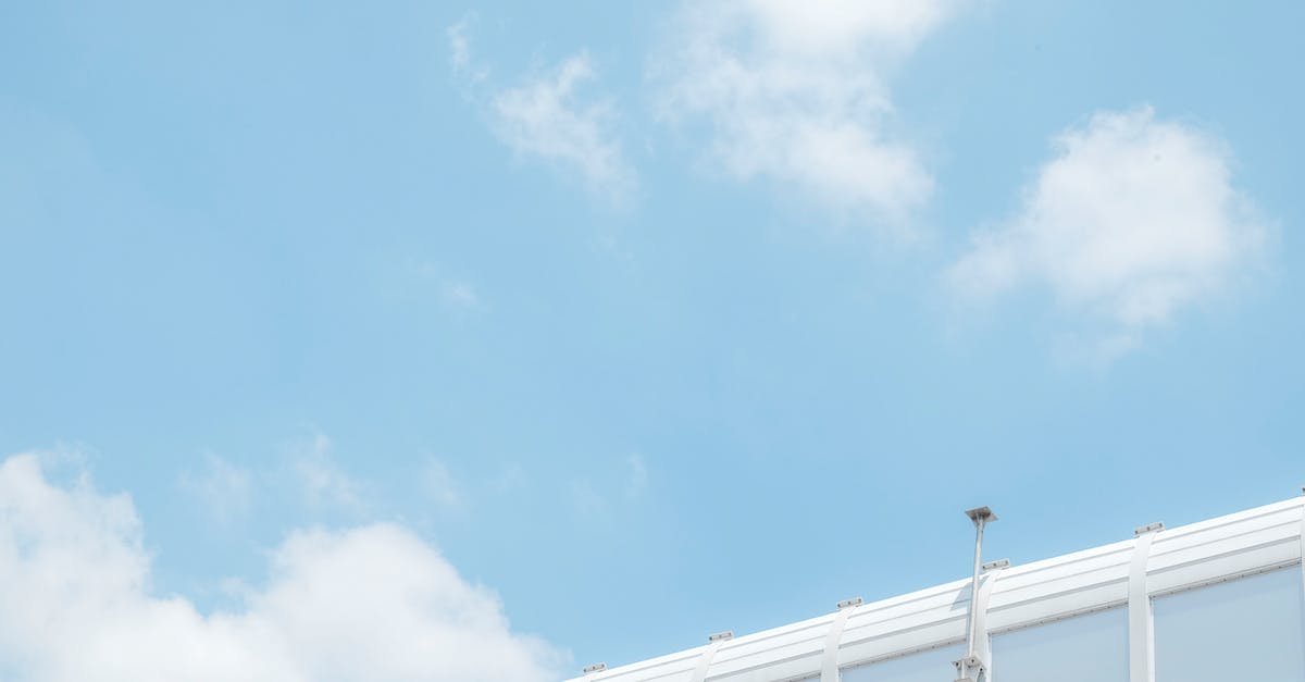 A large passenger jet flying through a cloudy blue sky