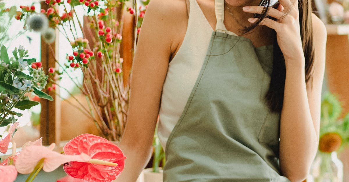 A person standing in front of a flower