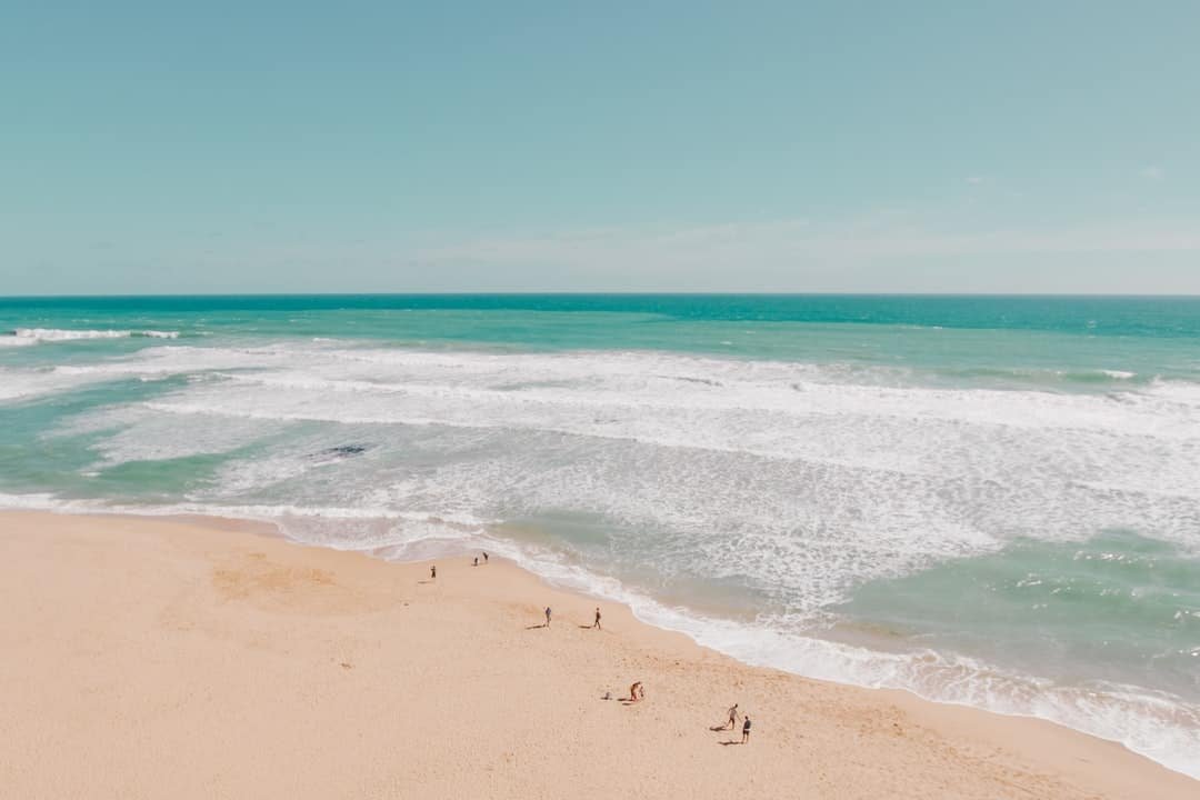 A sandy beach next to the ocean